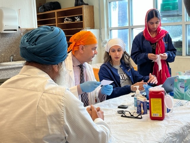 Volunteer doctors at a clinic table